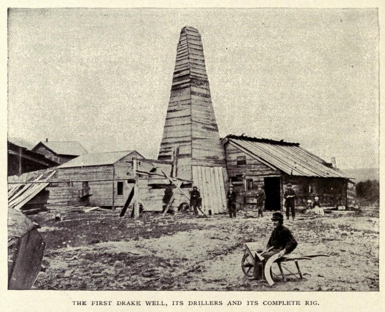 Black and White photo of the first wooden oil rig from 1902.