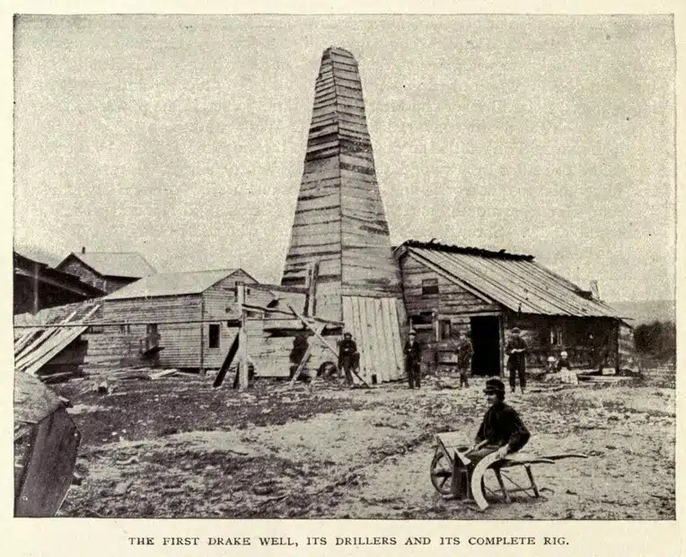 Black and White photo of the first wooden oil rig from 1902.